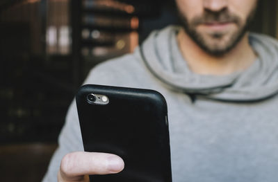 Midsection of man using mobile phone