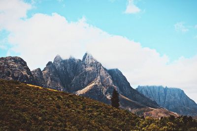 Scenic view of mountains against cloudy sky