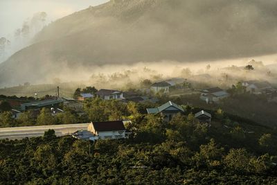 Scenic view of village by buildings against sky