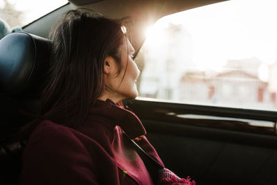 Relaxed woman in car st sunset. travel concept
