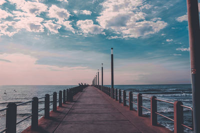 Pier over sea against sky