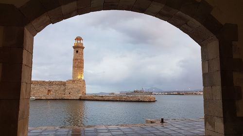 Historic building by sea against sky