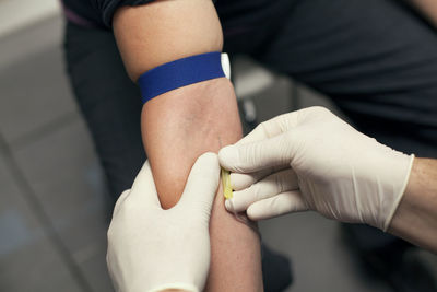 Cropped image of doctor injecting iv drip needle