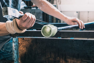 Manual worker making glass at workshop