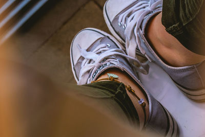 Low section of person wearing canvas shoes