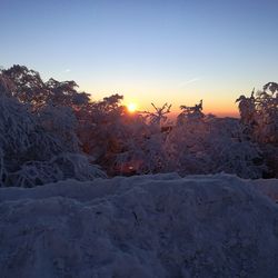 Scenic view of landscape against sky during winter