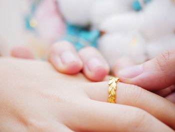 Cropped image of hands with gold wedding ring