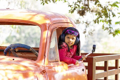 Portrait of girl sitting in car