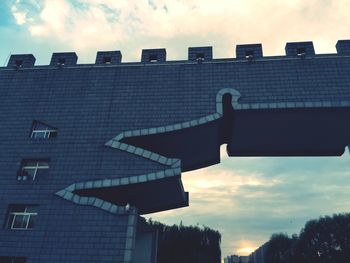 Low angle view of building against cloudy sky