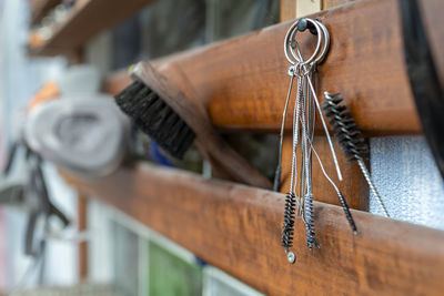 Close-up of rusty chain hanging on wood