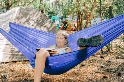 Portrait of woman lying down on hammock