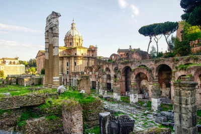 View of old temple building against cloudy sky