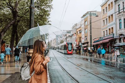 Woman on wet street in rainy season