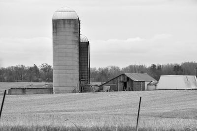 Barn on field against sky