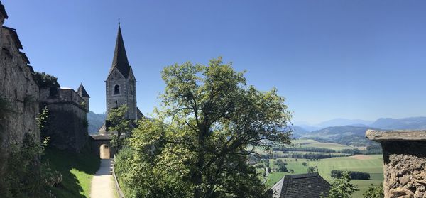 Panoramic view of trees and buildings against sky