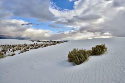 Scenic view of snow covered land against sky