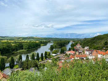 Scenic view of trees and buildings against sky