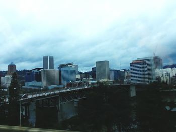 Buildings against cloudy sky