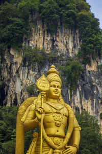 Statue of buddha against trees