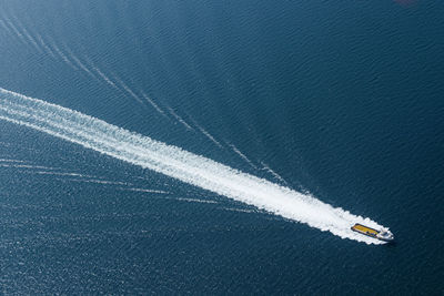 High angle view of airplane flying over sea