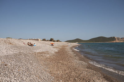 Scenic view of beach against clear sky