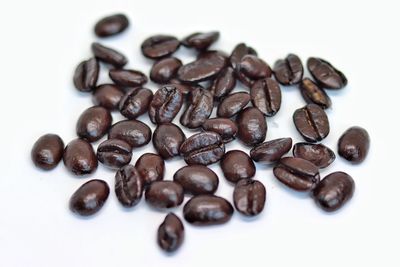 Close-up of coffee beans against white background