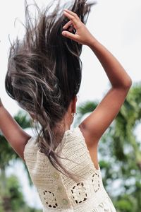 Rear view of woman with mobile phone standing outdoors