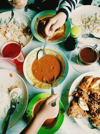 Cropped images of people having food at table