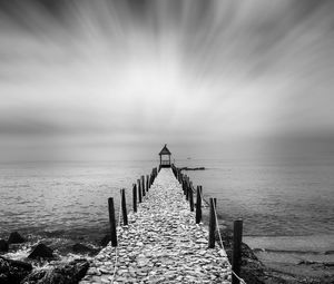 Pier over sea against sky