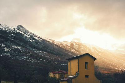 House on mountain against sky