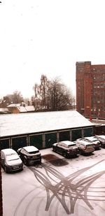 Snow covered city against clear sky