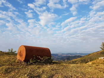 Hay bales on field against sky