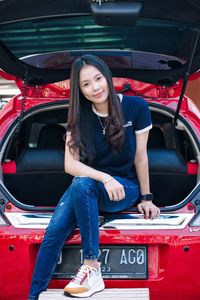 Portrait of young woman in car