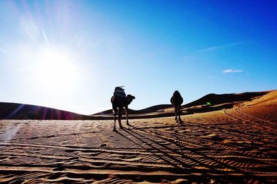 Man on desert against clear sky