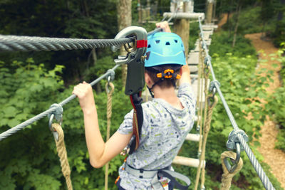 Full length of boy holding rope