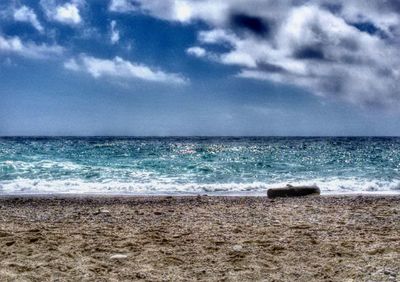 Scenic view of sea against cloudy sky