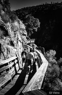 People on steps by mountain against sky