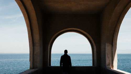 Rear view of man looking at sea