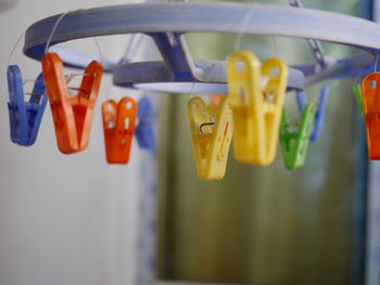 Close-up of colorful clothespins hanging at home