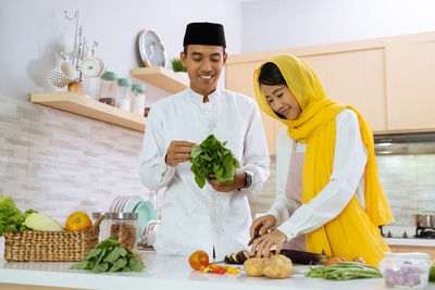 Man and woman standing by food