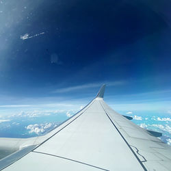 Low angle view of airplane flying in sky