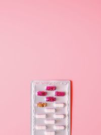 Close-up of pink over colored background