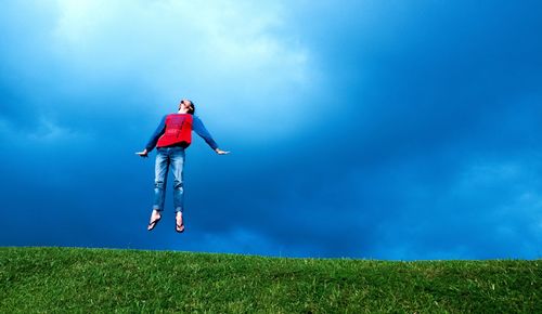 Woman on field against sky