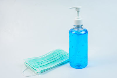 Close-up of blue bottle against white background