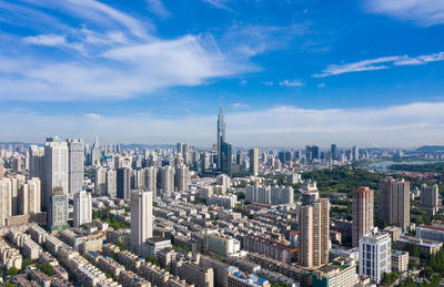 High angle view of modern buildings in city against sky