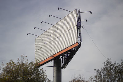 Low angle view of communications tower against sky