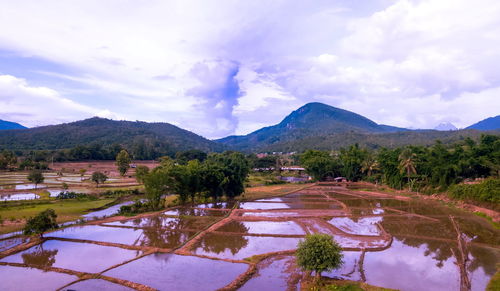 Scenic view of lake and mountains against sky