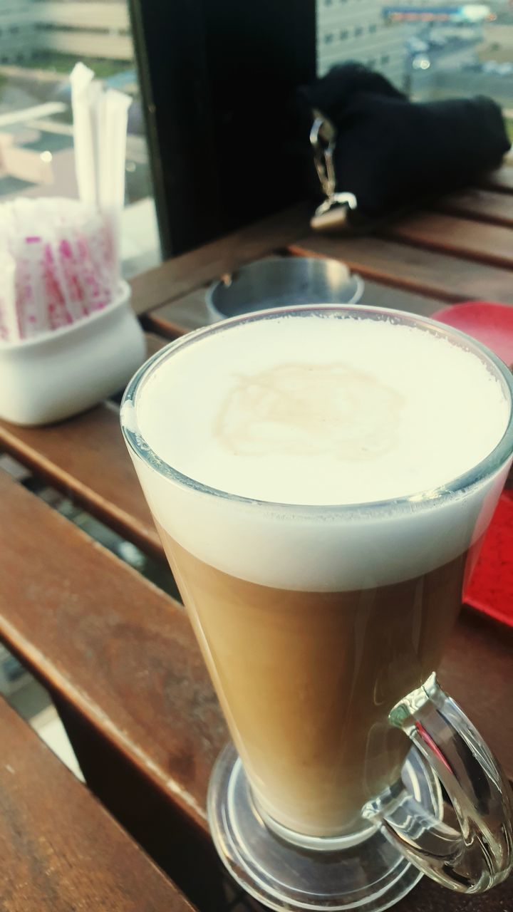 CLOSE-UP OF COFFEE CUP AND DRINK ON TABLE