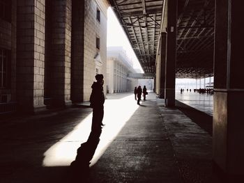 Silhouette of man walking in city