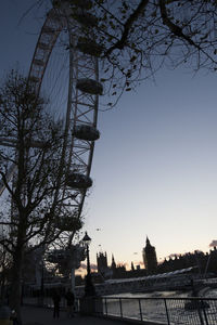 Low angle view of ferris wheel in city